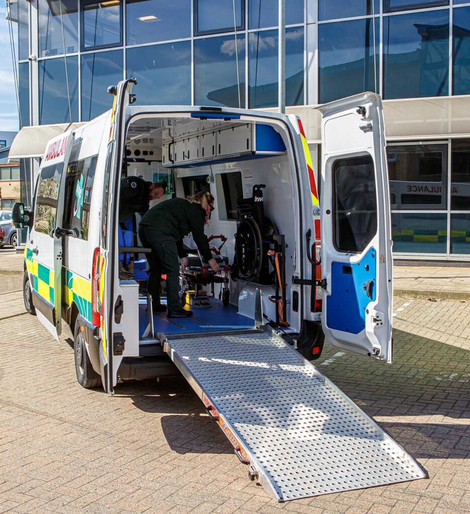 Ambulance Staff assisting patient on ramp