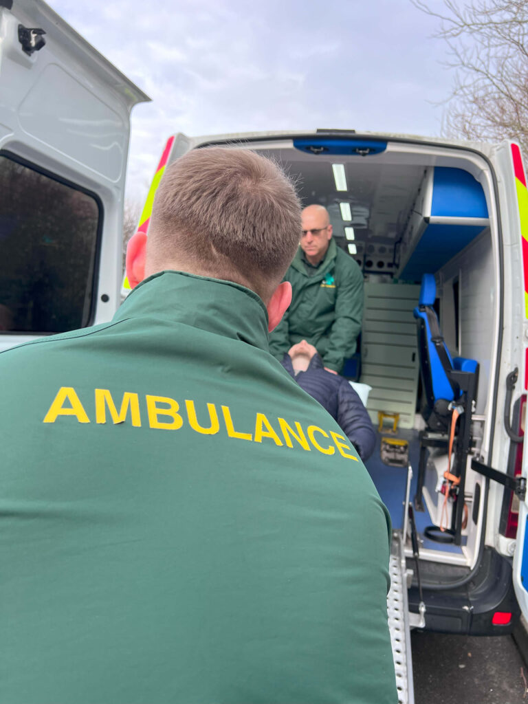 Ambulance staff loading patient into vehicle