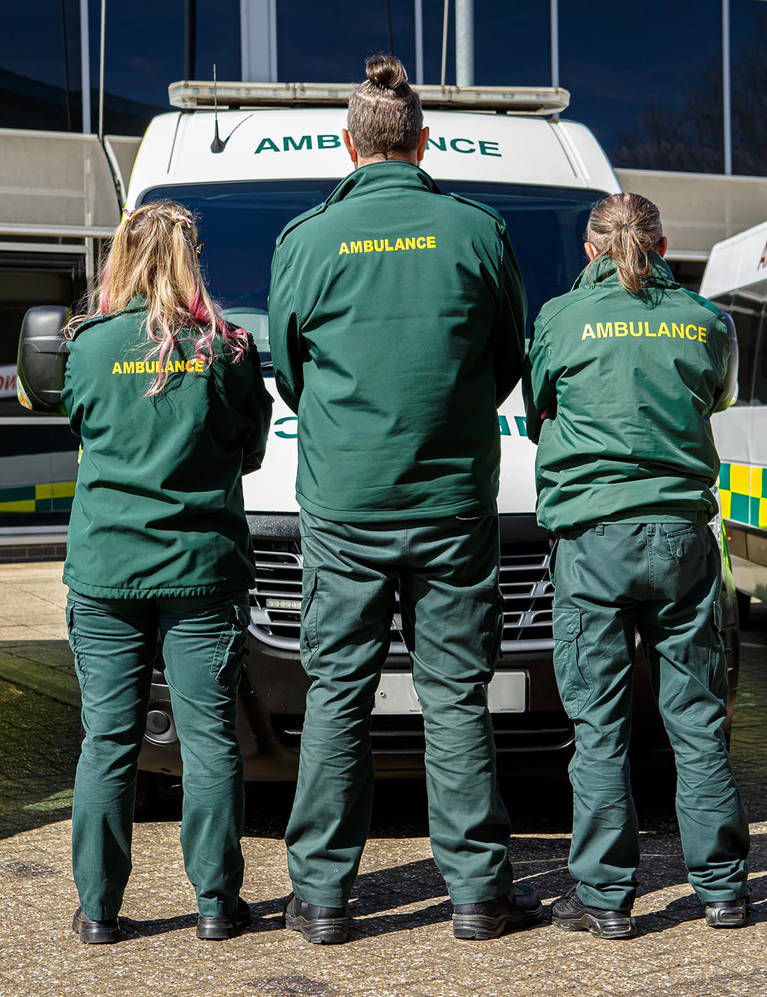 ambulance staff standing in front of vehicle