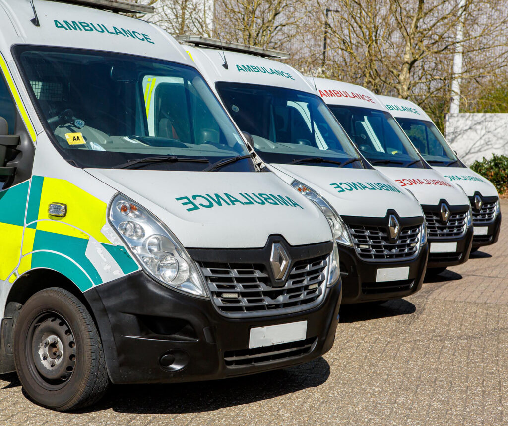 ambulance vehicles lined up parking lot
